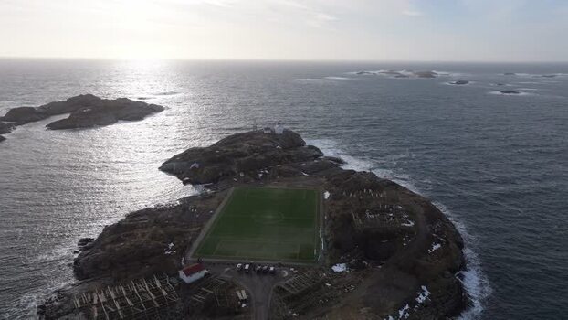 Aerial view of Lofoten soccer field on rocky island Norway.