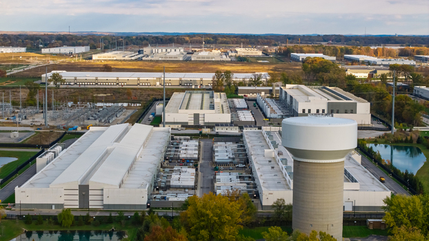 Aerial view of a large data center complex with industrial buildings cooling infrastructure and a prominent water tower in New Albany Ohio United States. Aerial view of a large data center complex with industrial buildings cooling infrastructure and a prominent water tower in New Albany Ohio United States.