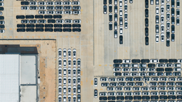 Aerial view of the BYD Thailand Rayong Office Building and rows of new electric vehicles parked in a large logistics lot Phananikhom Rayong Thailand.