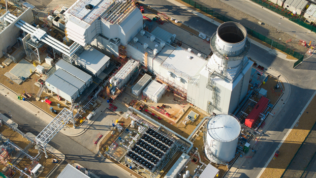 Aerial view of Millbrook Power Plant featuring industrial infrastructure cooling systems storage tanks and surrounding paved areas in Stewartby England United Kingdom. Aerial view of Millbrook Power Plant featuring industrial infrastructure cooling systems storage tanks and surrounding paved areas in Stewartby England United Kingdom.