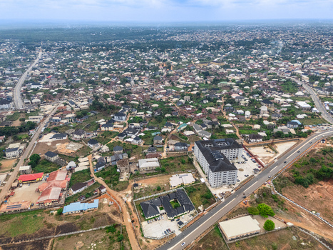 Aerial view of buildings and roads cutting through the landscape a tapestry of rooftops under a vast sky Umuahia Abia Nigeria. Aerial view of buildings and roads cutting through the landscape a tapestry of rooftops under a vast sky Umuahia Abia Nigeria.