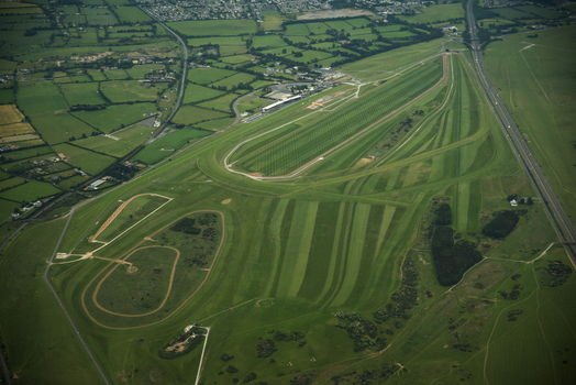 Waterford Regional Airport Ireland 02 July 2015 Aerial view of Waterford Airport runways and green airfield surrounded by lush countryside and a motorway.