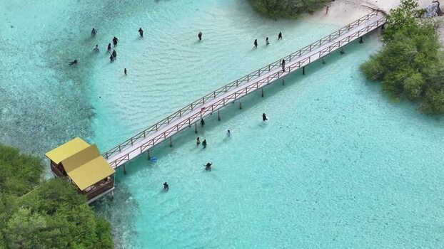Aerial view of a wooden bridge and people swimming Maldives. Aerial view of a wooden bridge and people swimming Maldives.