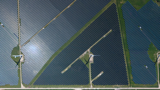 Aerial view of Chelveston Wind Farm showing rows of solar panels and wind turbines integrated into the landscape Wellingborough England United Kingdom. Aerial view of Chelveston Wind Farm showing rows of solar panels and wind turbines integrated into the landscape Wellingborough England United Kingdom.