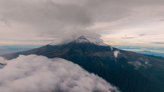 Aerial view of Parque Nacional Iztaccihuatl Popocatepetl with snow capped peaks volcanic slopes and thick clouds at sunset in Amecameca de Juarez Estado de Mexico Mexico.