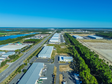 Wilmington North Carolina United States 27 September 2026 Aerial view of industrial warehouses and distribution centers located along a highway surrounded by forest and wetlands. Wilmington North Carolina United States 27 September 2026 Aerial view of industrial warehouses and distribution centers located along a highway surrounded by forest and wetlands.