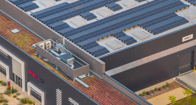 Alixan France 25 July 2026 Aerial view of the Aventech industrial facility in Rovaltain technology park featuring rooftop solar panels and green roof sections.