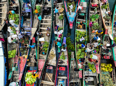 Rangamati Hill District Chittagong Division Bangladesh 18 May 2024 Aerial view of Kaptai Lake with boats carrying fresh produce and traders navigating the busy waterway.