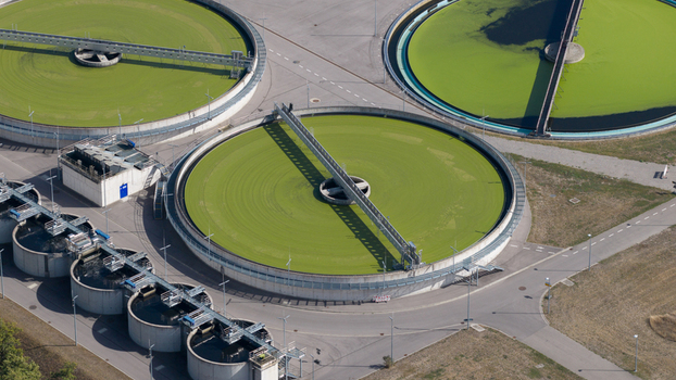 Aerial view of Klaerwerk Karlsruhe wastewater treatment plant with circular sedimentation tanks and industrial infrastructure in Karlsruhe Baden Wurttemberg Germany.