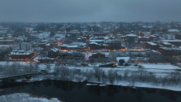 Aerial view of Lynchburg covered in fresh snow featuring historic brick buildings the James River and glowing city lights at dusk in Lynchburg Virginia United States. Aerial view of Lynchburg covered in fresh snow featuring historic brick buildings the James River and glowing city lights at dusk in Lynchburg Virginia United States.