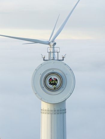 Netherlands 26 November 2025 Aerial view of two technicians sitting inside a wind turbine hub above a thick layer of clouds. Netherlands 26 November 2025 Aerial view of two technicians sitting inside a wind turbine hub above a thick layer of clouds.