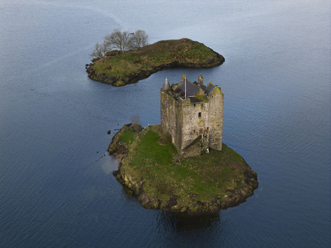 Aerial view of Castle Stalker situated on a small tidal islet surrounded by the calm waters of Loch Laich Appin Scotland United Kingdom. Aerial view of Castle Stalker situated on a small tidal islet surrounded by the calm waters of Loch Laich Appin Scotland United Kingdom.