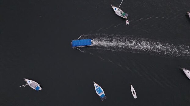 Aerial view of a boat moving through sailboats Brazil.