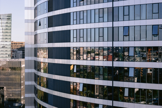 Aerial view of a modern glass skyscraper facade with city reflections in Vilnius Vilnius County Lithuania.