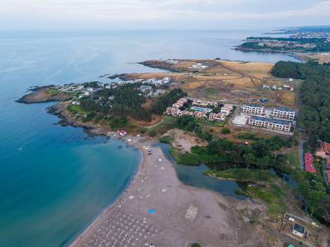Aerial view of Arapya Beach with its sandy shore surrounding holiday villas lush green trees and the calm blue waters of the Black Sea in Tsarevo Burgas Bulgaria. Aerial view of Arapya Beach with its sandy shore surrounding holiday villas lush green trees and the calm blue waters of the Black Sea in Tsarevo Burgas Bulgaria.