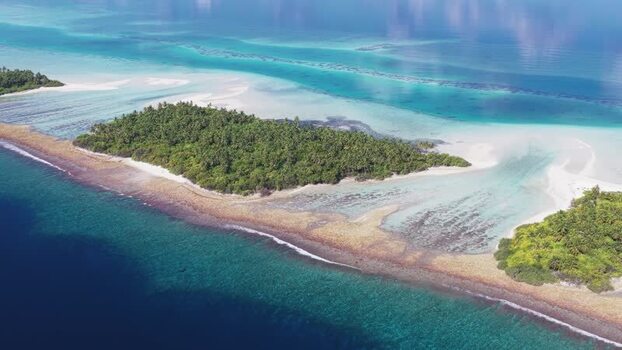 Aerial view of tropical islands and coral reefs in Maldives.
