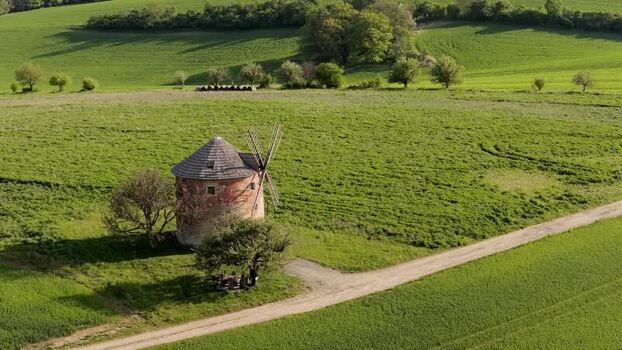 Aerial view of a historic windmill in green fields Czechia. Aerial view of a historic windmill in green fields Czechia.