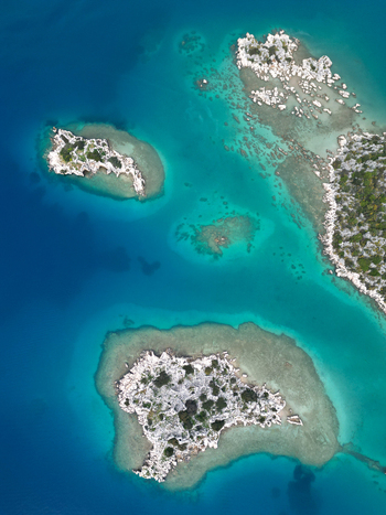 Aerial view of rocky islands and shallow reefs in turquoise water near the coast of Demre Antalya Turkiye. Aerial view of rocky islands and shallow reefs in turquoise water near the coast of Demre Antalya Turkiye.