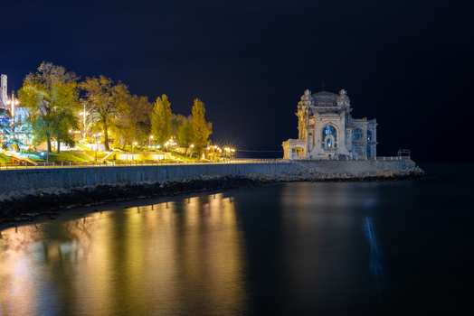 View of the illuminated Casino of Constanta at night situated on the waterfront with reflections on the dark sea Constanta Judetul Constanta Romania. View of the illuminated Casino of Constanta at night situated on the waterfront with reflections on the dark sea Constanta Judetul Constanta Romania.
