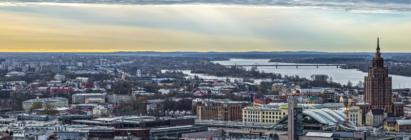 Aerial view of the Riga skyline featuring the Latvian Academy of Sciences building historic rooftops and the Daugava River under a soft sky in Riga Latvia. Aerial view of the Riga skyline featuring the Latvian Academy of Sciences building historic rooftops and the Daugava River under a soft sky in Riga Latvia.
