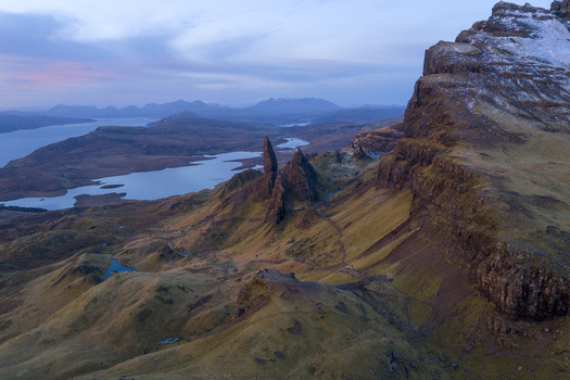 Aerial view of The Storr rock formation with dramatic pinnacles and rugged cliffs overlooking Loch Leathan Isle of Skye Scotland United Kingdom. Aerial view of The Storr rock formation with dramatic pinnacles and rugged cliffs overlooking Loch Leathan Isle of Skye Scotland United Kingdom.
