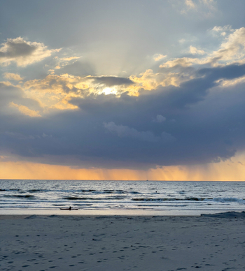 View of Strand Wijk aan Zee with sunbeams breaking through dramatic clouds over the North Sea Wijk aan Zee North Holland Netherlands. View of Strand Wijk aan Zee with sunbeams breaking through dramatic clouds over the North Sea Wijk aan Zee North Holland Netherlands.