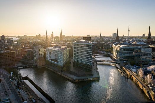 Aerial view of modern office buildings and historic church spires along the canals at sunset in Hamburg Hamburg Germany. Aerial view of modern office buildings and historic church spires along the canals at sunset in Hamburg Hamburg Germany.