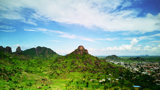 Aerial view of the rocky hills of Dass surrounded by lush green vegetation and the outskirts of the town in Bauchi Bauchi Nigeria.