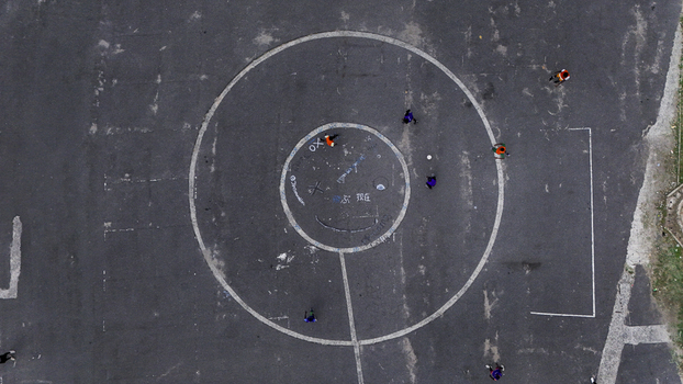 Aerial view of the center circle of a sports court at National Stadium Surulere with people playing on the dark asphalt surface in Lagos Lagos Nigeria. Aerial view of the center circle of a sports court at National Stadium Surulere with people playing on the dark asphalt surface in Lagos Lagos Nigeria.