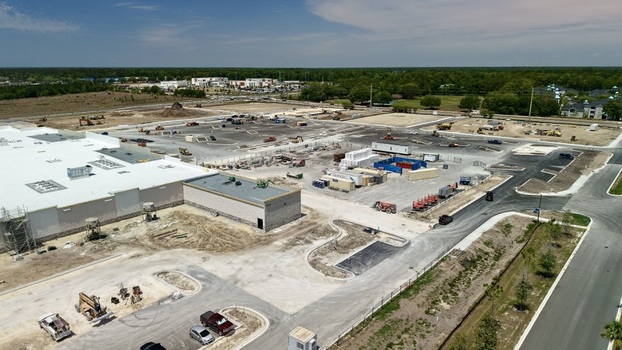 Aerial view of the construction site at Foundry Lane with heavy machinery and a large white building under development World Golf Village Florida United States.