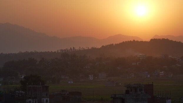 View of sunset over a valley town Nepal