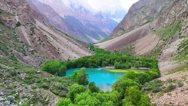 Aerial view of turquoise lake and Qullai Vudor peak Tajikistan. Aerial view of turquoise lake and Qullai Vudor peak Tajikistan.