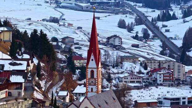 Aerial view of Nauders church in the snowy village Austria.