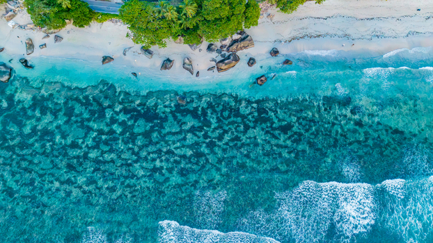 Aerial view of Beau Vallon Beach with turquoise water coral reefs and sandy shoreline in Beau Vallon Seychelles.