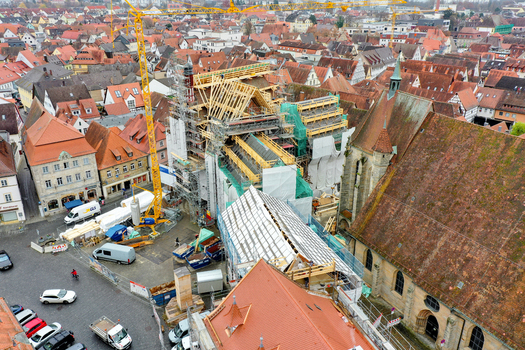 Aerial view of the Rathaus Forchheim under renovation with scaffolding and cranes surrounded by historic red tiled rooftops in Forchheim Bayern Germany. Aerial view of the Rathaus Forchheim under renovation with scaffolding and cranes surrounded by historic red tiled rooftops in Forchheim Bayern Germany.