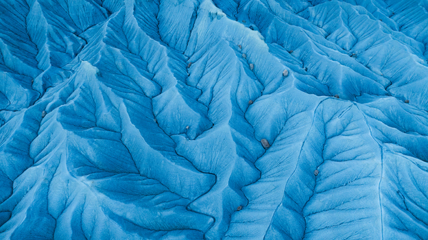 Aerial view of the intricate blue toned badlands landscape with deep erosion patterns and rocky ridges in Hanksville Utah United States.