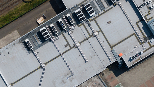 Aerial view of industrial HVAC systems and ventilation units on a large flat roof near railway tracks in Utrecht Utrecht Netherlands. Aerial view of industrial HVAC systems and ventilation units on a large flat roof near railway tracks in Utrecht Utrecht Netherlands.