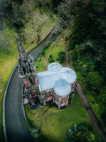 Aerial view of Ermida da Senhora da Vit&oacute;ria s gothic architecture stands in stark contrast to the lush green landscape Furnas Portugal.