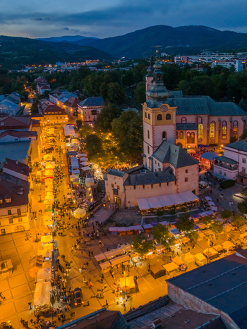 Aerial view of Radvansky jarmok traditional market with illuminated stalls crowds of people and historic architecture in Banska Bystrica Banskobystricky kraj Slovakia.