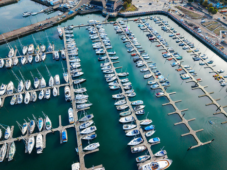 Aerial view of Bangor Harbour and Town with numerous yachts and sailboats docked in rows within the marina in Bangor Northern Ireland United Kingdom.