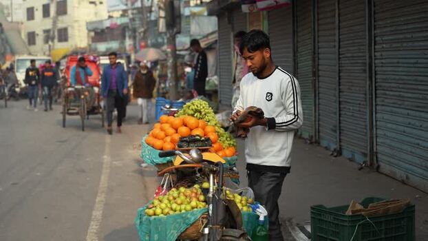 View of a street vendor with a fruit cart in Bogura Bangladesh.