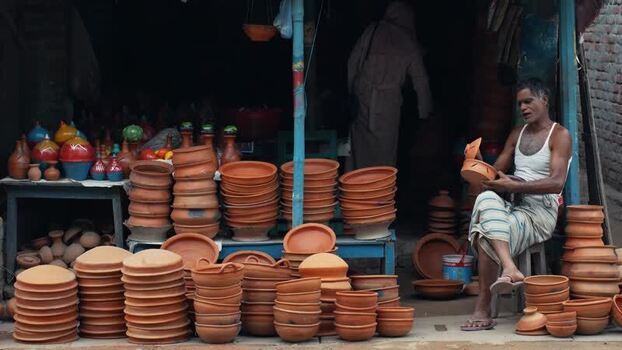View of a potter with clay pottery in Chapai Nawabganj Bangladesh. View of a potter with clay pottery in Chapai Nawabganj Bangladesh.