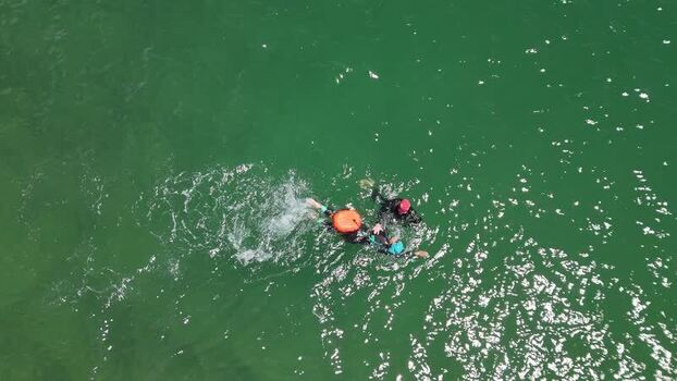 Aerial view of people swimming in the green sea Portugal.