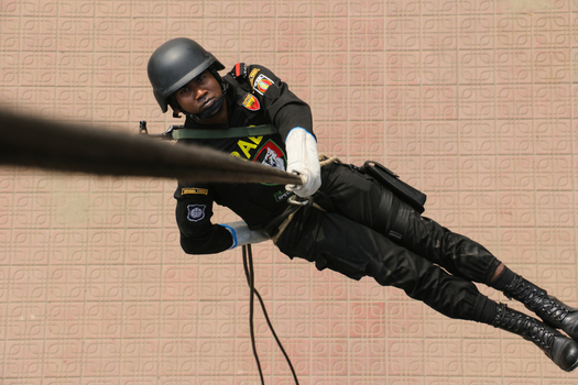 Dhaka Bangladesh 06 January 2017 View of a Rapid Action Battalion member rappelling down a rope during a tactical demonstration at the RAB Headquarters. Dhaka Bangladesh 06 January 2017 View of a Rapid Action Battalion member rappelling down a rope during a tactical demonstration at the RAB Headquarters.