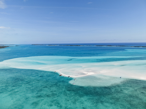 Aerial view of Man O War Cay Sandbar with small boats and people surrounded by turquoise water in Rolletown Exuma The Bahamas. Aerial view of Man O War Cay Sandbar with small boats and people surrounded by turquoise water in Rolletown Exuma The Bahamas.