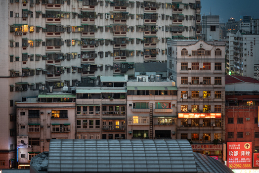 View of dense residential buildings with illuminated windows and balconies in the Sanchong District New Taipei City Taiwan. View of dense residential buildings with illuminated windows and balconies in the Sanchong District New Taipei City Taiwan.