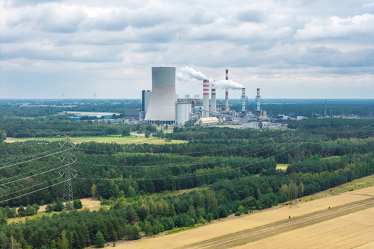 Aerial view of a large coal fired thermal power station with cooling towers and chimneys emitting smoke in Poland. Aerial view of a large coal fired thermal power station with cooling towers and chimneys emitting smoke in Poland.