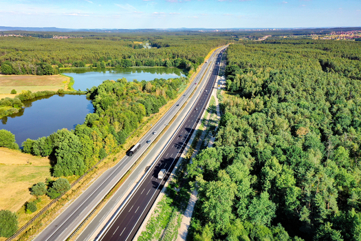 Nurnberg Germany 18 May 2024 Aerial view of the A73 motorway passing through dense green forests and near small lakes under a clear blue sky. Nurnberg Germany 18 May 2024 Aerial view of the A73 motorway passing through dense green forests and near small lakes under a clear blue sky.