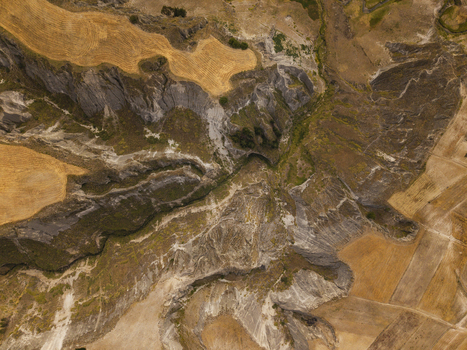 Aerial view of the rugged Toachi River Canyon featuring steep rock formations and golden agricultural fields in the high Andean landscape of Zumbahua Cotopaxi Ecuador. Aerial view of the rugged Toachi River Canyon featuring steep rock formations and golden agricultural fields in the high Andean landscape of Zumbahua Cotopaxi Ecuador.