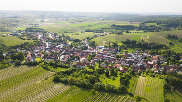 Aerial view of a picturesque village nestled amidst rolling green vineyards a tapestry of autumnal hues contrasting with the terracotta rooftops Falkenstein bei Poysdorf Lower Austria Austria. Aerial view of a picturesque village nestled amidst rolling green vineyards a tapestry of autumnal hues contrasting with the terracotta rooftops Falkenstein bei Poysdorf Lower Austria Austria.